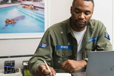 person in military uniform working at a computer